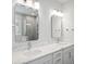 Bathroom with marble countertops, dual sinks, and tile shower with glass door at 349 Wappoo Trace Ln, Summerville, SC 29486
