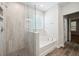 Bathroom with a tub, tiled shower, and window, with modern fixtures at 349 Wappoo Trace Ln, Summerville, SC 29486