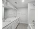 Bright bathroom featuring a double vanity, bathtub and shower, and a large mirror at 349 Wappoo Trace Ln, Summerville, SC 29486