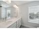 Bright bathroom featuring double vanity, large mirror, and a window for natural light at 349 Wappoo Trace Ln, Summerville, SC 29486