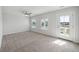 Bright bedroom with carpet, ceiling fan, two windows, and a door to a balcony at 349 Wappoo Trace Ln, Summerville, SC 29486