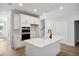 Bright kitchen with modern white cabinetry, stone countertops, and stainless steel appliances at 349 Wappoo Trace Ln, Summerville, SC 29486
