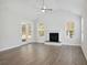 Bright living room featuring a fireplace, wood floors, and a ceiling fan at 349 Wappoo Trace Ln, Summerville, SC 29486