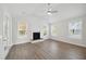 Bright living room featuring a fireplace, wood floors, and a ceiling fan at 349 Wappoo Trace Ln, Summerville, SC 29486