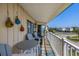 Cozy balcony with outdoor dining and scenic street view of the neighborhood at 3701 Dock Site Rd # 302, Edisto Beach, SC 29438
