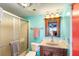 Bathroom with a shower, toilet, vanity with a wooden cabinet and bright blue walls at 3701 Dock Site Rd # 302, Edisto Beach, SC 29438