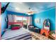 Bright bedroom with colorful accents, striped bedding, ceiling fan, and access to a private balcony at 3701 Dock Site Rd # 302, Edisto Beach, SC 29438