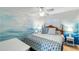 Stylish bedroom with a unique ocean-themed accent wall and coastal decor at 3701 Dock Site Rd # 302, Edisto Beach, SC 29438