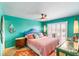 Comfortable bedroom with vibrant turquoise walls and a unique mermaid decoration at 3701 Dock Site Rd # 302, Edisto Beach, SC 29438