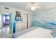 Bright bedroom with ocean-themed accent wall and double closet at 3701 Dock Site Rd # 302, Edisto Beach, SC 29438