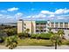Beautiful condo building features balconies, manicured landscaping, and ocean proximity on a sunny day at 3701 Dock Site Rd # 302, Edisto Beach, SC 29438