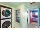 Hallway featuring laundry machines, an art piece, and an entrance to the bedroom at 3701 Dock Site Rd # 302, Edisto Beach, SC 29438