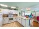 Well-lit kitchen featuring white cabinetry, updated appliances, and seamless flow to the living area at 3701 Dock Site Rd # 302, Edisto Beach, SC 29438