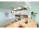 Well-lit kitchen with white cabinets, updated appliances, and beach-themed decor at 3701 Dock Site Rd # 302, Edisto Beach, SC 29438