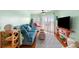 Bright living room with stylish furnishings, hardwood floors, and sliding glass doors at 3701 Dock Site Rd # 302, Edisto Beach, SC 29438
