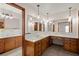 Bathroom featuring dual marble sinks with wood cabinetry and a large mirror at 4322 Bream Rd, North Charleston, SC 29418