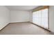 Bright bedroom with neutral carpet, large window, and simple decor at 4322 Bream Rd, North Charleston, SC 29418