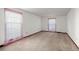 Bright bedroom with neutral carpet and walls, featuring large windows with sheer pink curtains at 4322 Bream Rd, North Charleston, SC 29418