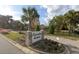 Evanston Estates community entrance sign with lush landscaping, mature palm trees and beautiful stone details at 4322 Bream Rd, North Charleston, SC 29418