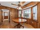 Cozy dining area with wood-paneled walls, decorative windows, and a classic chandelier at 4322 Bream Rd, North Charleston, SC 29418