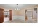 Formal dining room with chandelier, traditional wallpaper, and adjacent rooms at 4322 Bream Rd, North Charleston, SC 29418