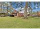 A backyard with a brick house, a trampoline, a grill, a gazebo, and a large tree providing ample shade at 462 Mount Royall Dr, Mount Pleasant, SC 29464