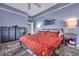Bedroom with blue walls, a ceiling fan, a bed with red floral bedding, and two bedside tables with lamps at 462 Mount Royall Dr, Mount Pleasant, SC 29464
