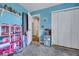 Bedroom with blue walls, a closet, and an open doorway leading to an adjacent room, filled with toys at 462 Mount Royall Dr, Mount Pleasant, SC 29464