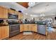 A kitchen features wooden cabinets, stainless steel appliances, and a view into an adjacent dining and living space at 462 Mount Royall Dr, Mount Pleasant, SC 29464