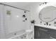 Modern bathroom featuring a sleek vanity, round mirror, and a stylish shower with black fixtures at 4757 June St, North Charleston, SC 29405