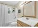 Beautiful bathroom boasts with an updated vanity, new mirror, and great natural lighting at 4757 June St, North Charleston, SC 29405