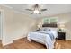 Cozy bedroom featuring a ceiling fan, warm wood floors, and a comfortable-looking bed at 4757 June St, North Charleston, SC 29405