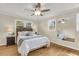 Bright bedroom with hardwood floors, neutral walls, ceiling fan, and a comfortable queen-sized bed at 4757 June St, North Charleston, SC 29405