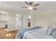 Bedroom featuring hardwood floors, ceiling fan, and doors to closet and bathrooms at 4757 June St, North Charleston, SC 29405