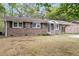 Traditional brick home with black shutters and well-maintained lawn at 4757 June St, North Charleston, SC 29405