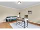 Bright living room features a work space, a comfortable couch, and well-maintained hardwood floors at 4757 June St, North Charleston, SC 29405