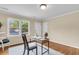 Bright living room with hardwood floors, a large window view, and a compact workspace desk and chair at 4757 June St, North Charleston, SC 29405