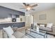 Open-concept living room with cozy seating, a ceiling fan, and a view into the kitchen area at 4757 June St, North Charleston, SC 29405