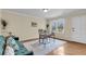 Bright living room features a work space, a comfortable couch, and a view from a large window at 4757 June St, North Charleston, SC 29405