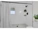 Updated shower with stylish tile, window, black hardware, and sleek shower head at 4757 June St, North Charleston, SC 29405
