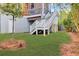 A serene backyard showcases stairs leading to the upper level, framed by a well-maintained lawn and mature trees at 490 Sanders Farm Ln, Charleston, SC 29492