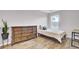 Well-lit bedroom with hardwood floors, wooden dresser, and minimalist decor at 490 Sanders Farm Ln, Charleston, SC 29492