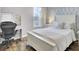 Cozy bedroom with a white bed frame and a dedicated desk and chair space at 490 Sanders Farm Ln, Charleston, SC 29492