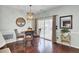 Dining area with light walls, hardwood floor, chandelier, art, and view to deck at 490 Sanders Farm Ln, Charleston, SC 29492