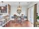 An inviting dining room features hardwood floors, a stylish light fixture, and sliding glass doors to outdoor space at 490 Sanders Farm Ln, Charleston, SC 29492
