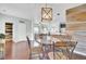 Spacious dining area features hardwood floors, a decorative chandelier, and connects seamlessly to the kitchen at 490 Sanders Farm Ln, Charleston, SC 29492