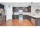 Kitchen with stainless steel appliances, dark wood cabinets, light countertops, and tile backsplash at 490 Sanders Farm Ln, Charleston, SC 29492