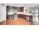 Spacious kitchen with stainless steel appliances, dark wood cabinets, light countertops, and tile backsplash at 490 Sanders Farm Ln, Charleston, SC 29492