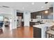 An open-concept kitchen has stainless steel appliances, dark wood cabinets, and light countertops at 490 Sanders Farm Ln, Charleston, SC 29492