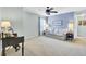 The living room has plush carpet, a ceiling fan, and natural light from a window, creating an inviting atmosphere at 490 Sanders Farm Ln, Charleston, SC 29492